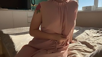 A Woman In A Soft Pink Dress Explores Her Intimacy
